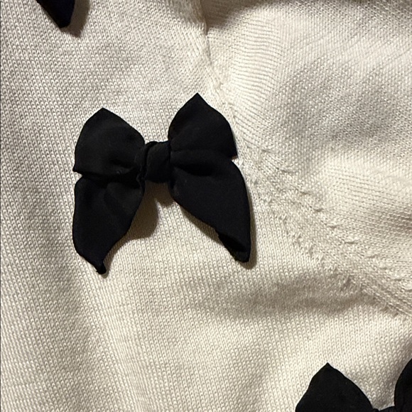 Kate Spade Ruthie Bow Cardigan in cream with black bows. - Picture 5 of 8